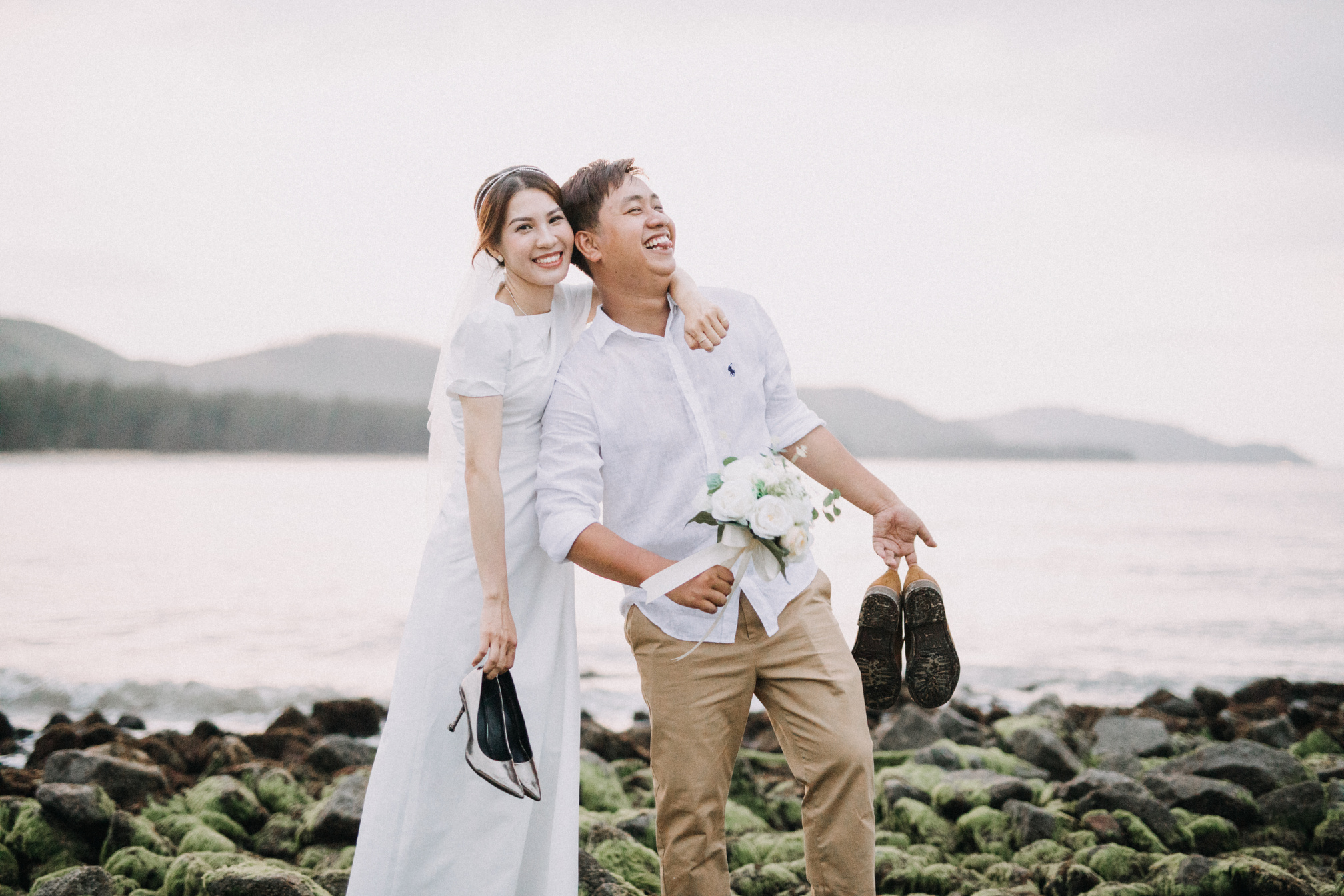 Woman in White Dress Shirt Holding Bouquet of Flowers