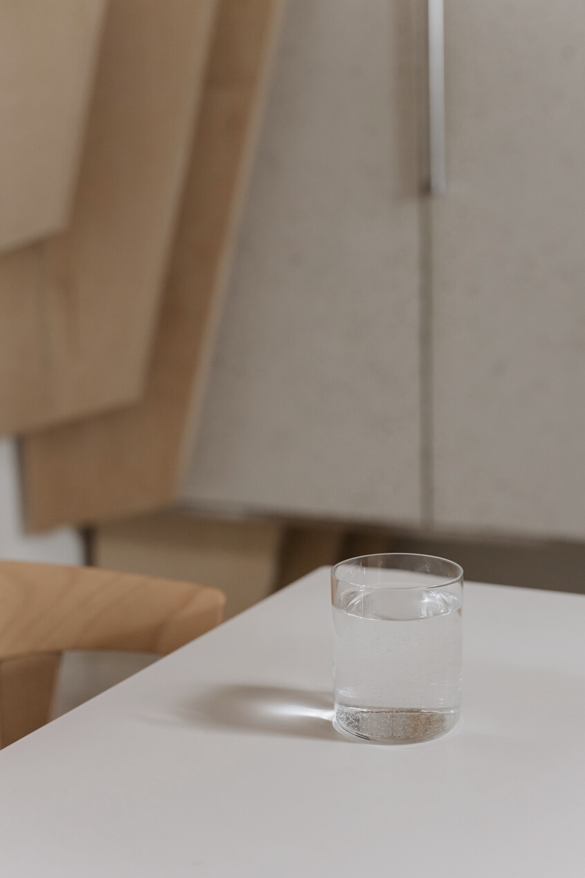 Clear Drinking Glass of Water on White Table